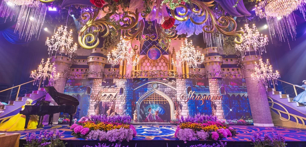 Cinderellas castle dual staircases with color flower beds for a Disney princess-themed celebration