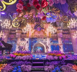 Cinderellas castle dual staircases with color flower beds for a Disney princess-themed celebration