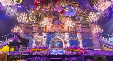 Cinderellas castle dual staircases with color flower beds for a Disney princess-themed celebration