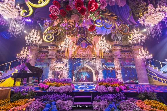 Cinderellas castle dual staircases with color flower beds for a Disney princess-themed celebration