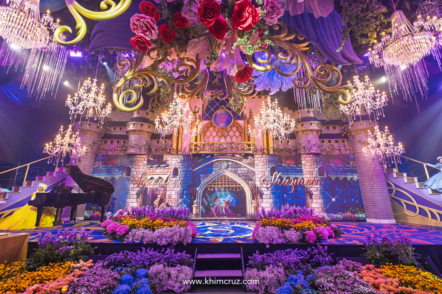 Cinderellas castle dual staircases with color flower beds for a Disney princess-themed celebration