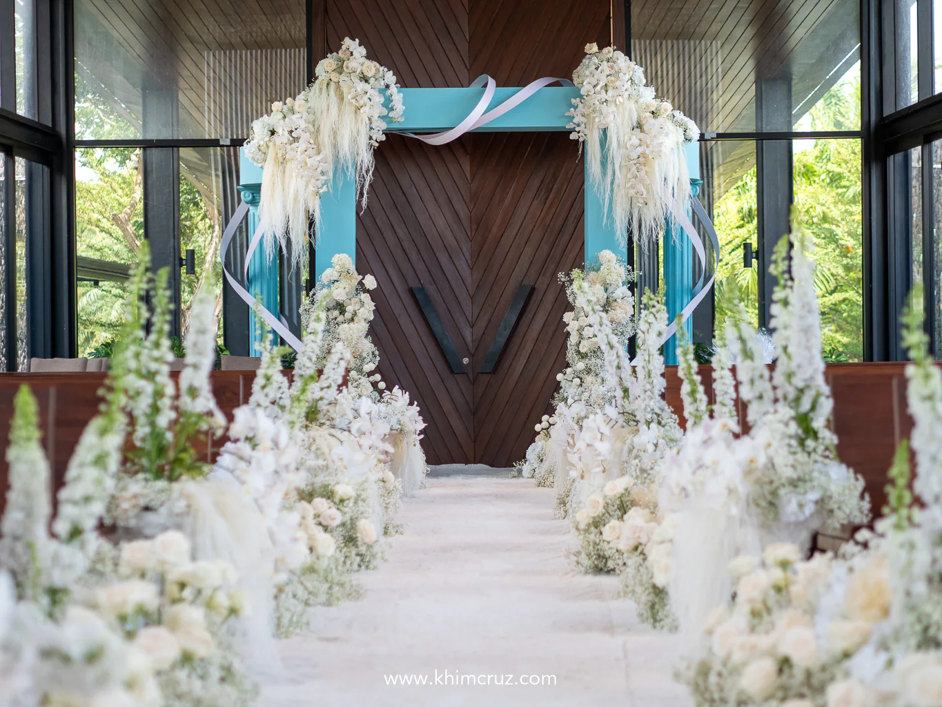 Tiffany-inspired wedding ceremony with entrance arch inspired by iconic blue box wrapped in signature white ribbon