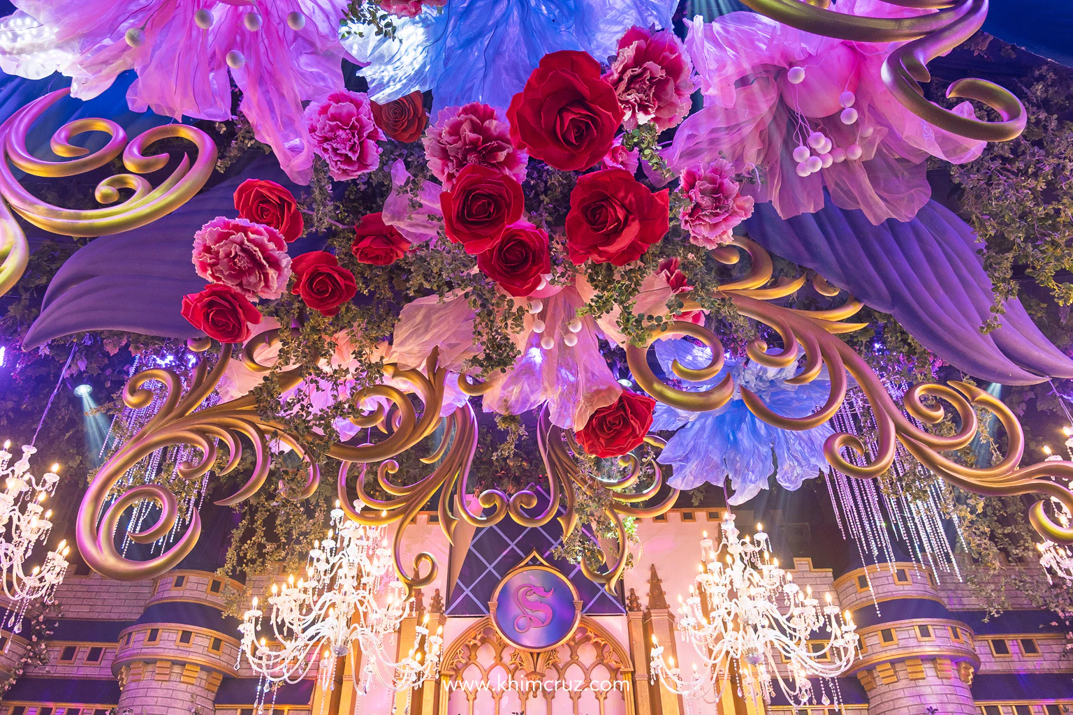 beautiful ceiling works featuring large florals chandeliers arches of this Disney-inspired celebration
