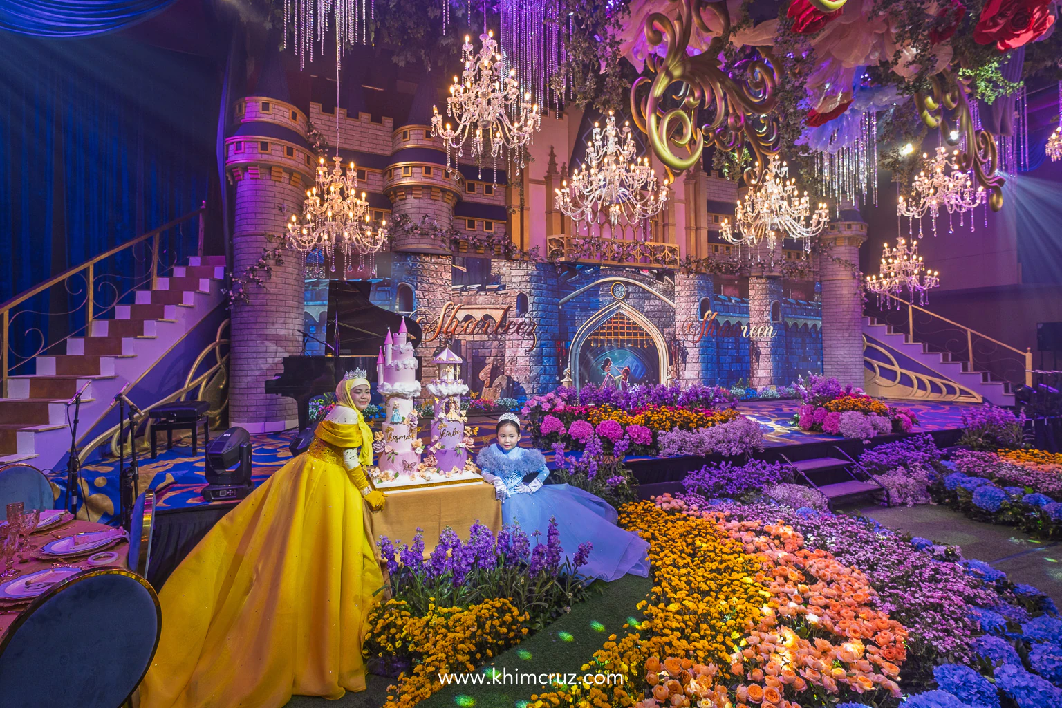 celebrants with their princess castle cake on a Disney princess-themed celebration