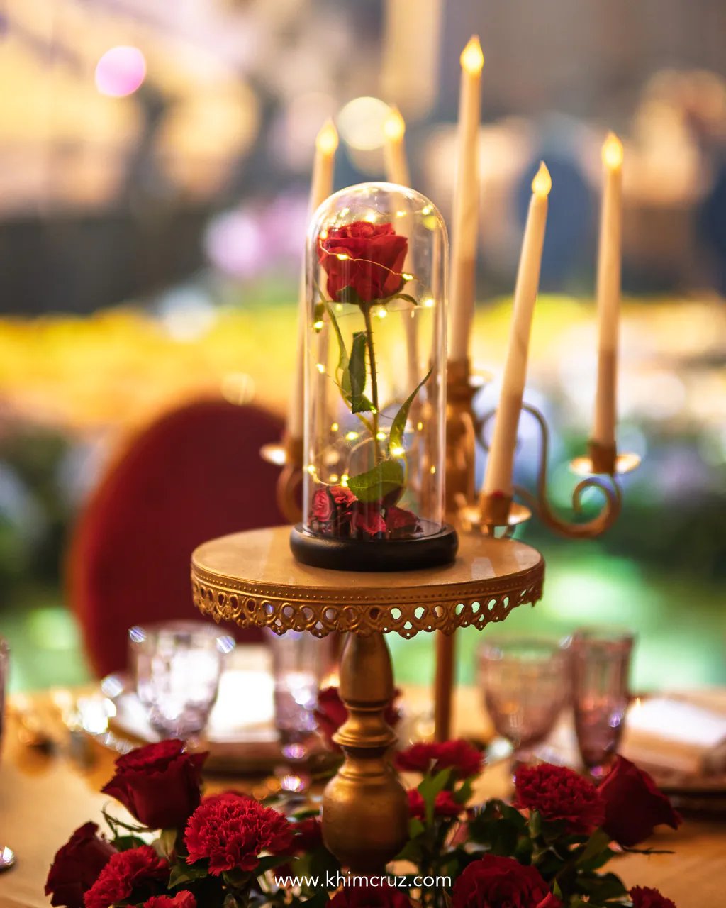 flower in a glass with candles on this beauty and the beast inspired table centerpiece