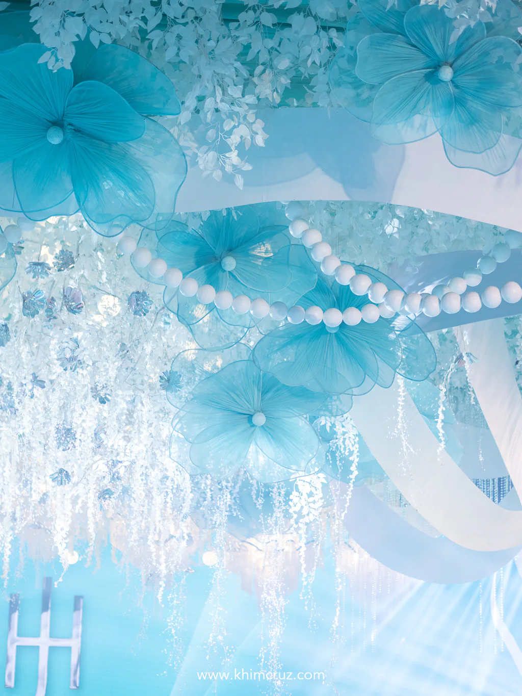 large hanging florals white ribbons pearls and crystals as ceiling installation