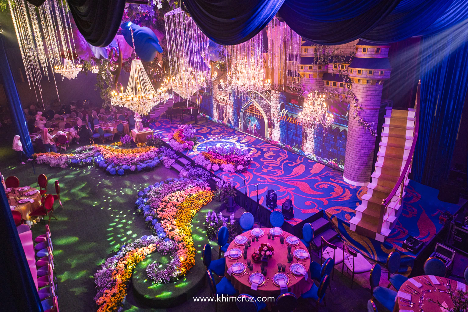 overview of the Disney princess-themed celebration showing the Cinderella castle and colorful floral beds
