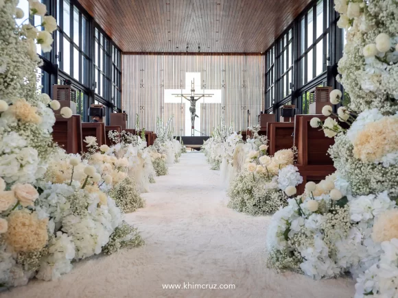 wedding ceremony aisle in white florals for timeless sophistication