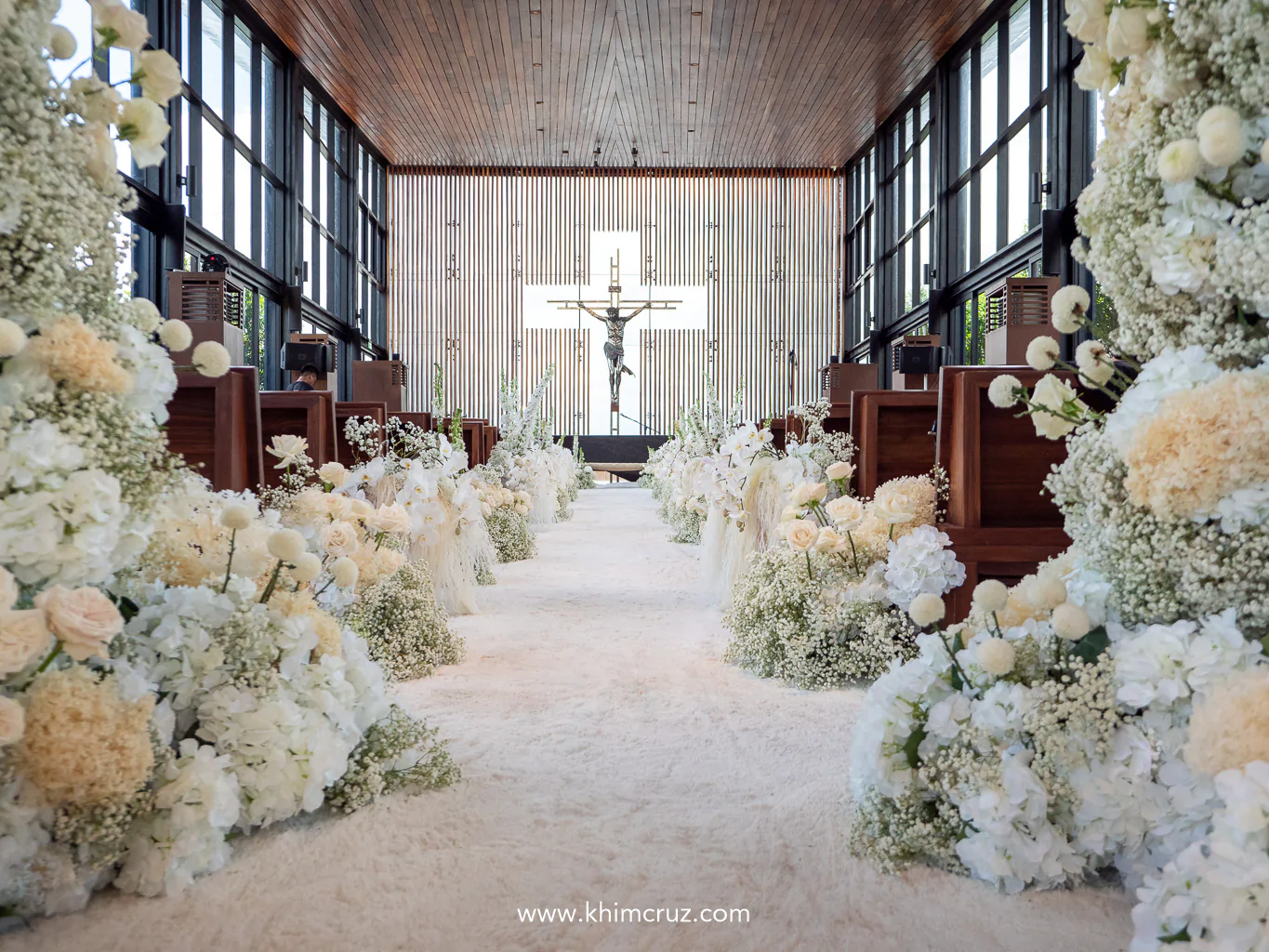 wedding ceremony aisle in white florals for timeless sophistication