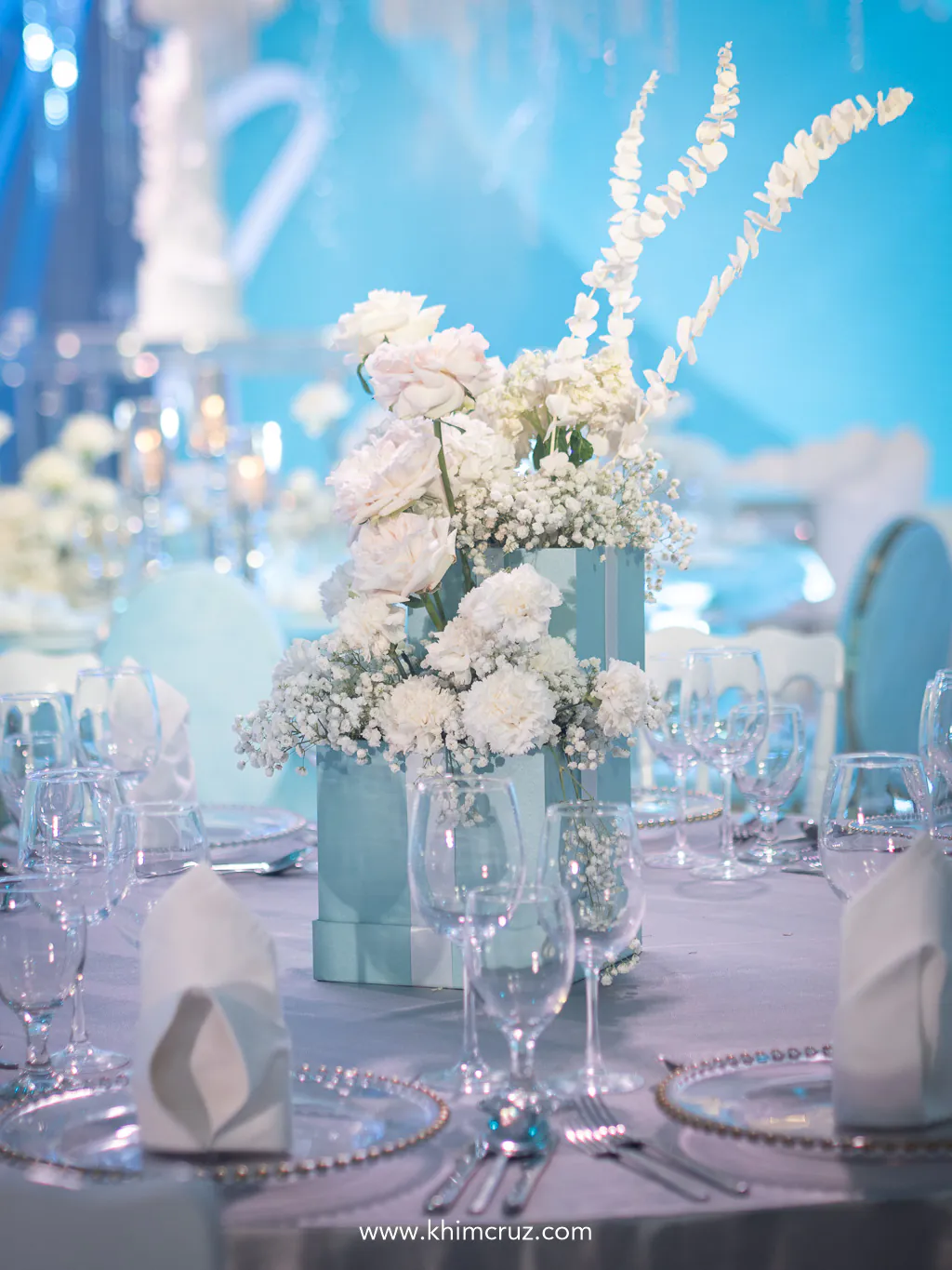 white florals as guest table centerpieces on this elegant wedding