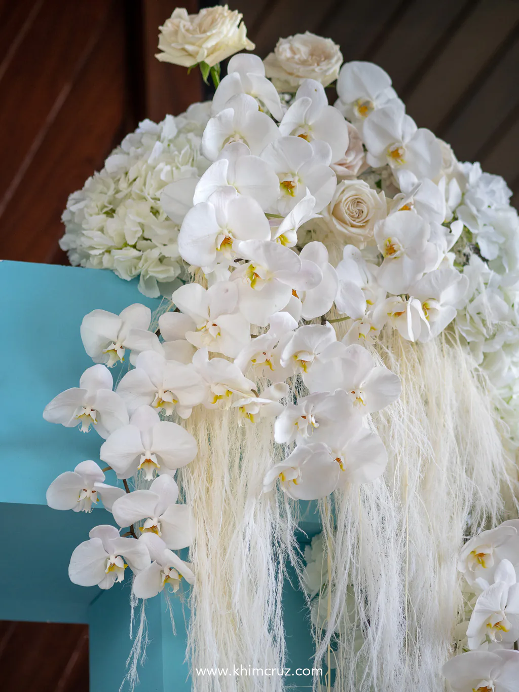 white florals on top of iconic blue box arch