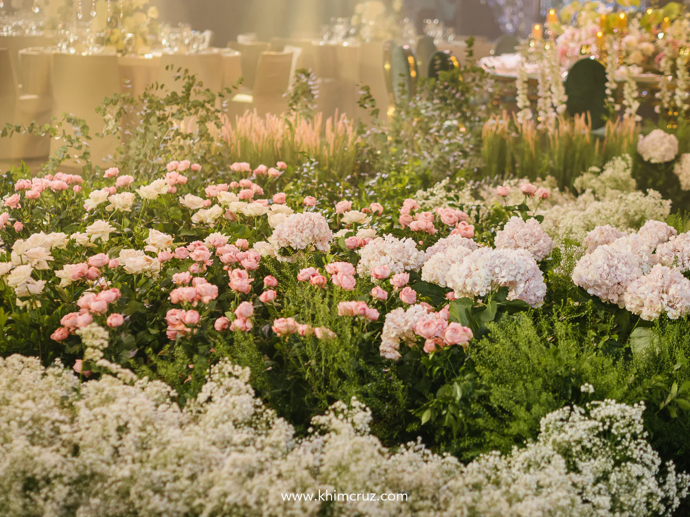 abundance of blooms cascaded across the reception floor, creating a lush, garden-like dreamscape