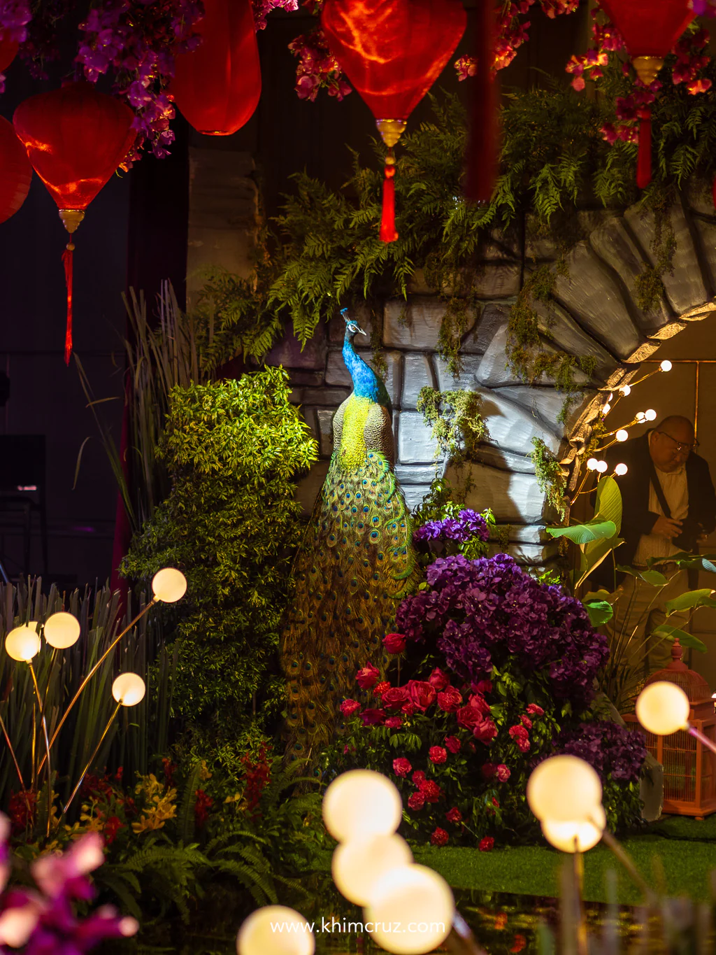 debutant enters like royalty through moon gates guarded by golden peacocks at her Crazy Rich Asians-inspired debut