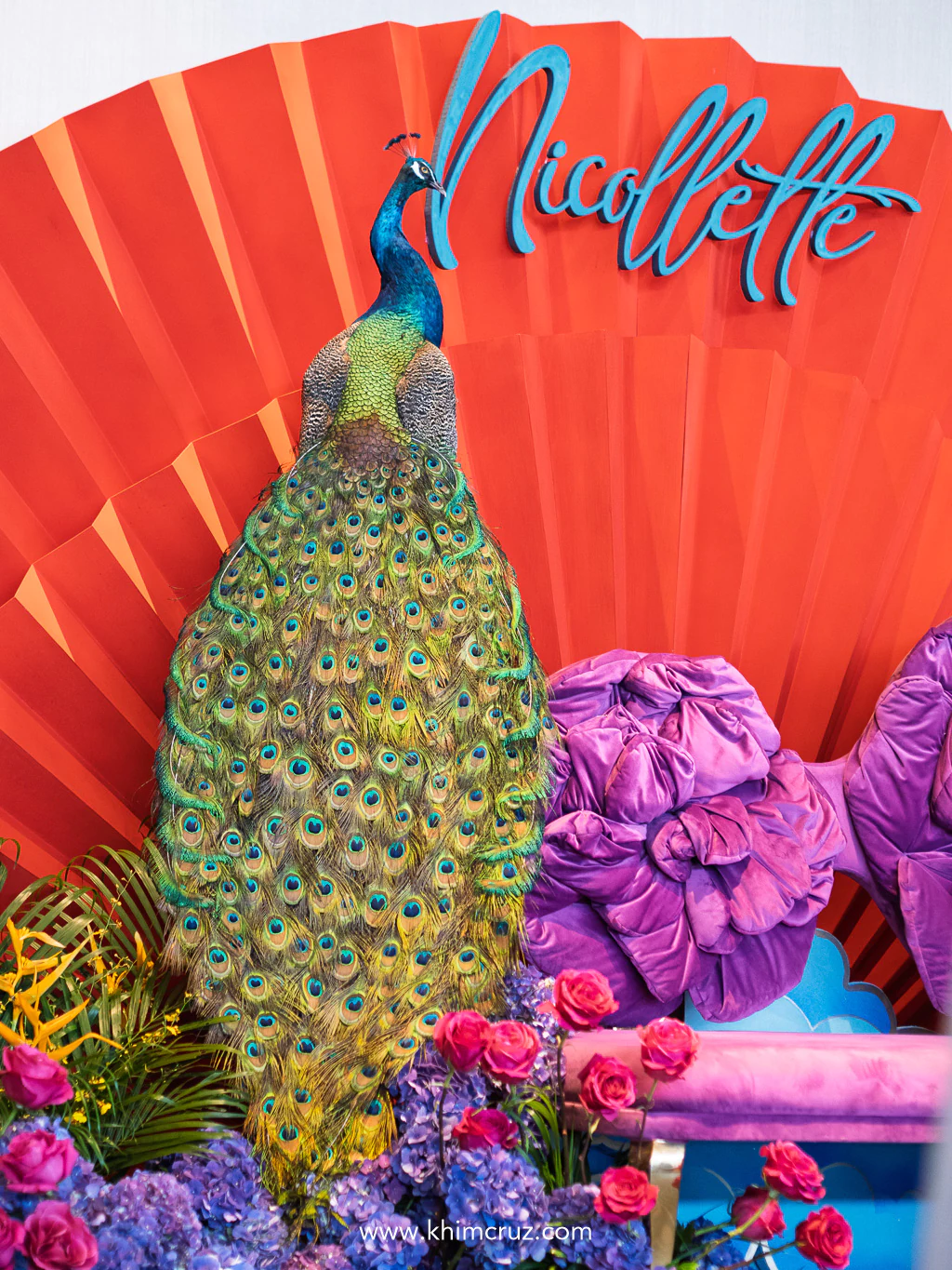 flanked by peacock at a Crazy Rich Asians-inspired debut