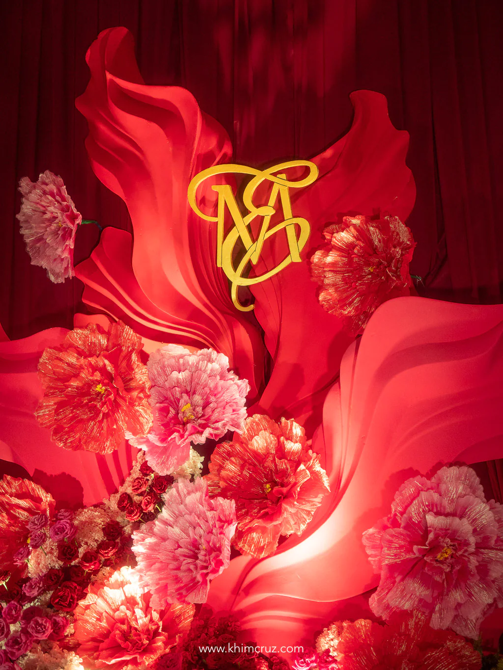 red-draped-floral-photo-backdrop-gold-monogram-oriental-wedding-khim-cruz